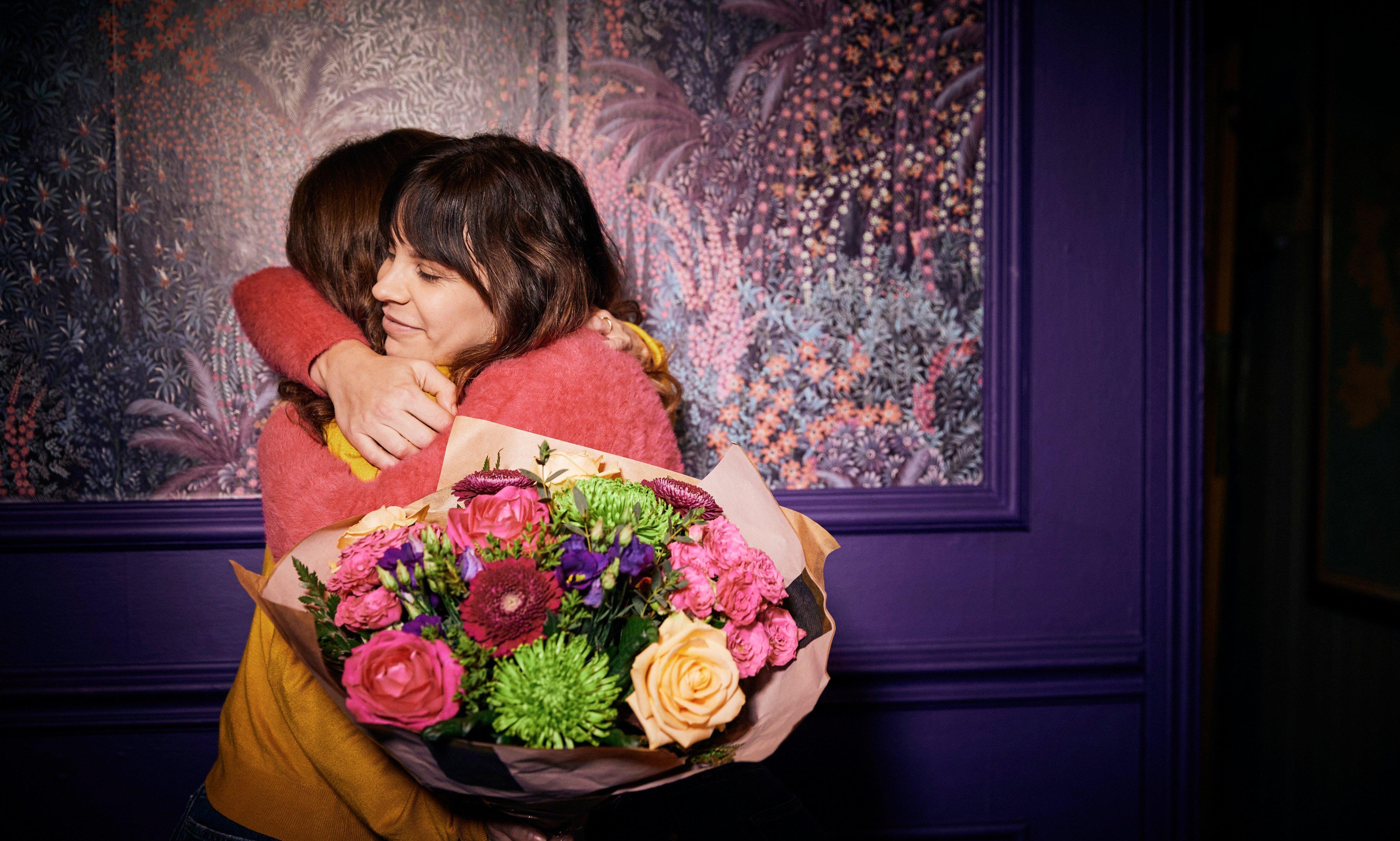 Women gifting flowers
