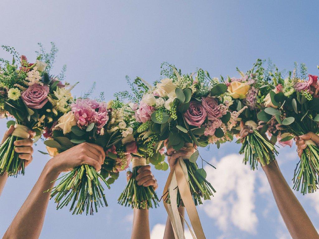 bride-and-bridesmaids-bouquets-in-air