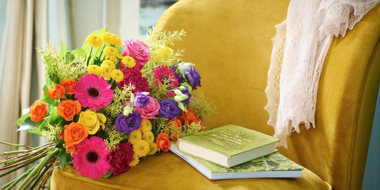 bright-bouquet-on-armchair-with-books