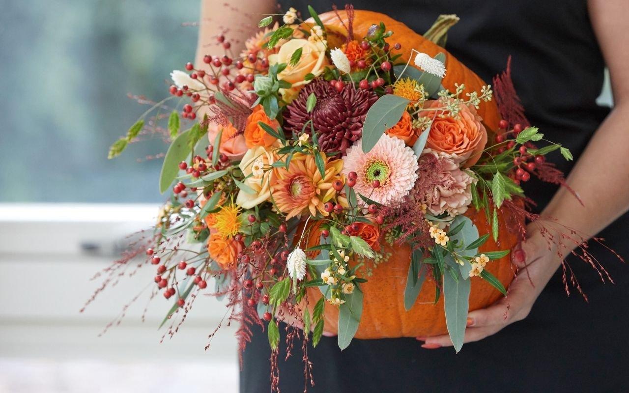 florist-holding-unique-pumpkin-floral-display