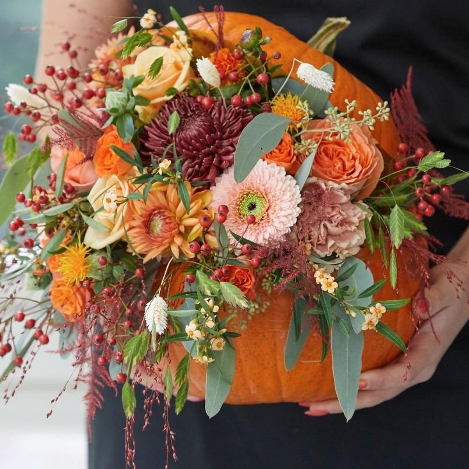 florist-holding-unique-pumpkin-floral-display