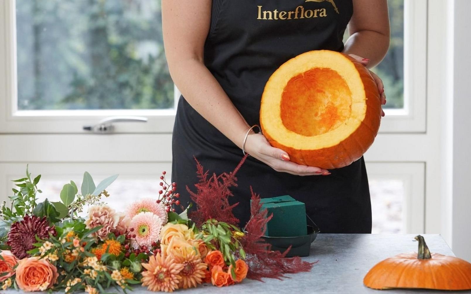 florist-presenting-empty-pumpkin-for-arrangement