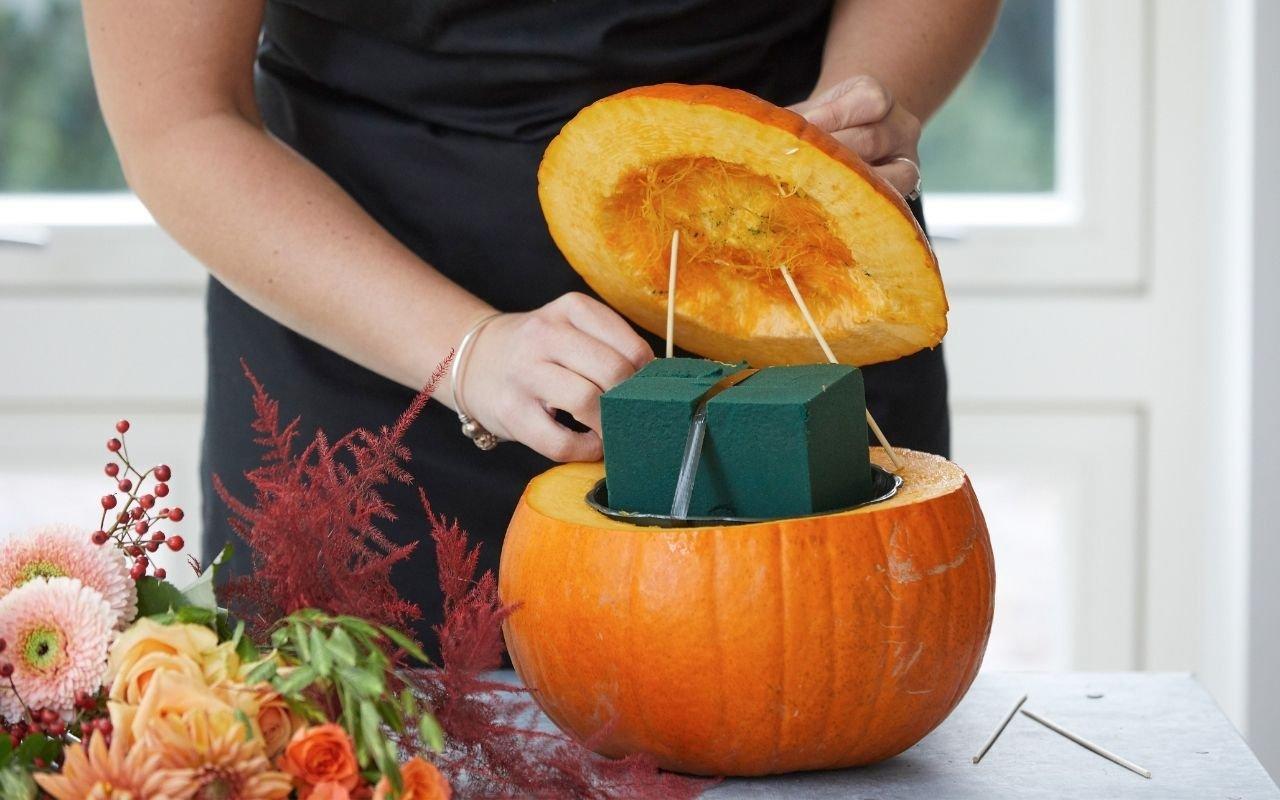 florist-setting-up-pumpkin-floral-arrangement