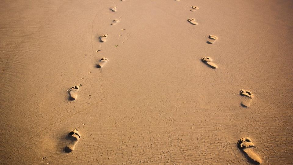 footprints-in-sand-stock