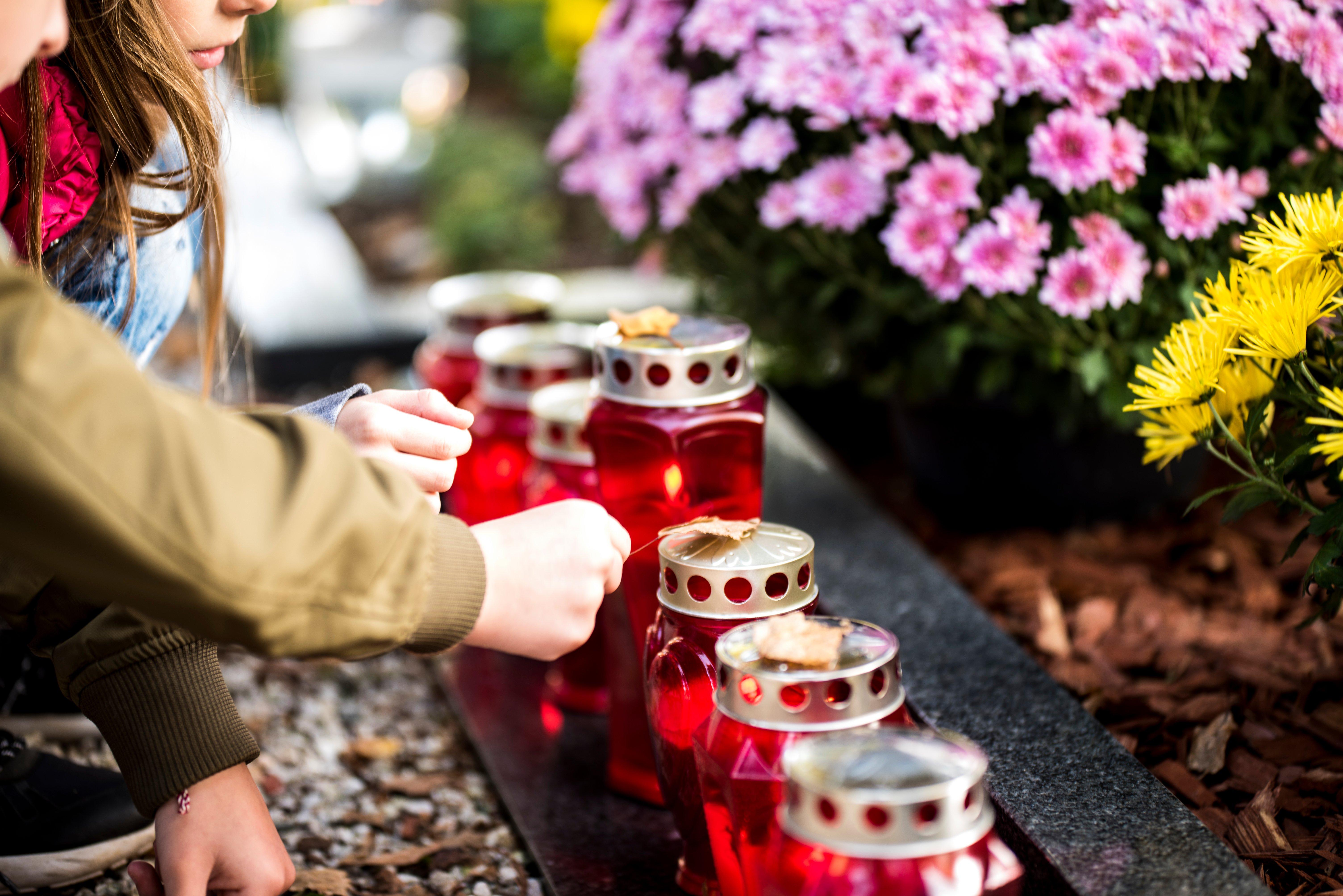 people-lighting-memorial-candles