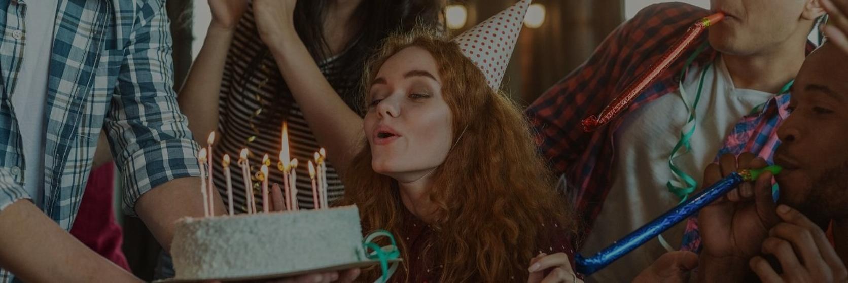woman-blowing-candles-on-a-cake-out