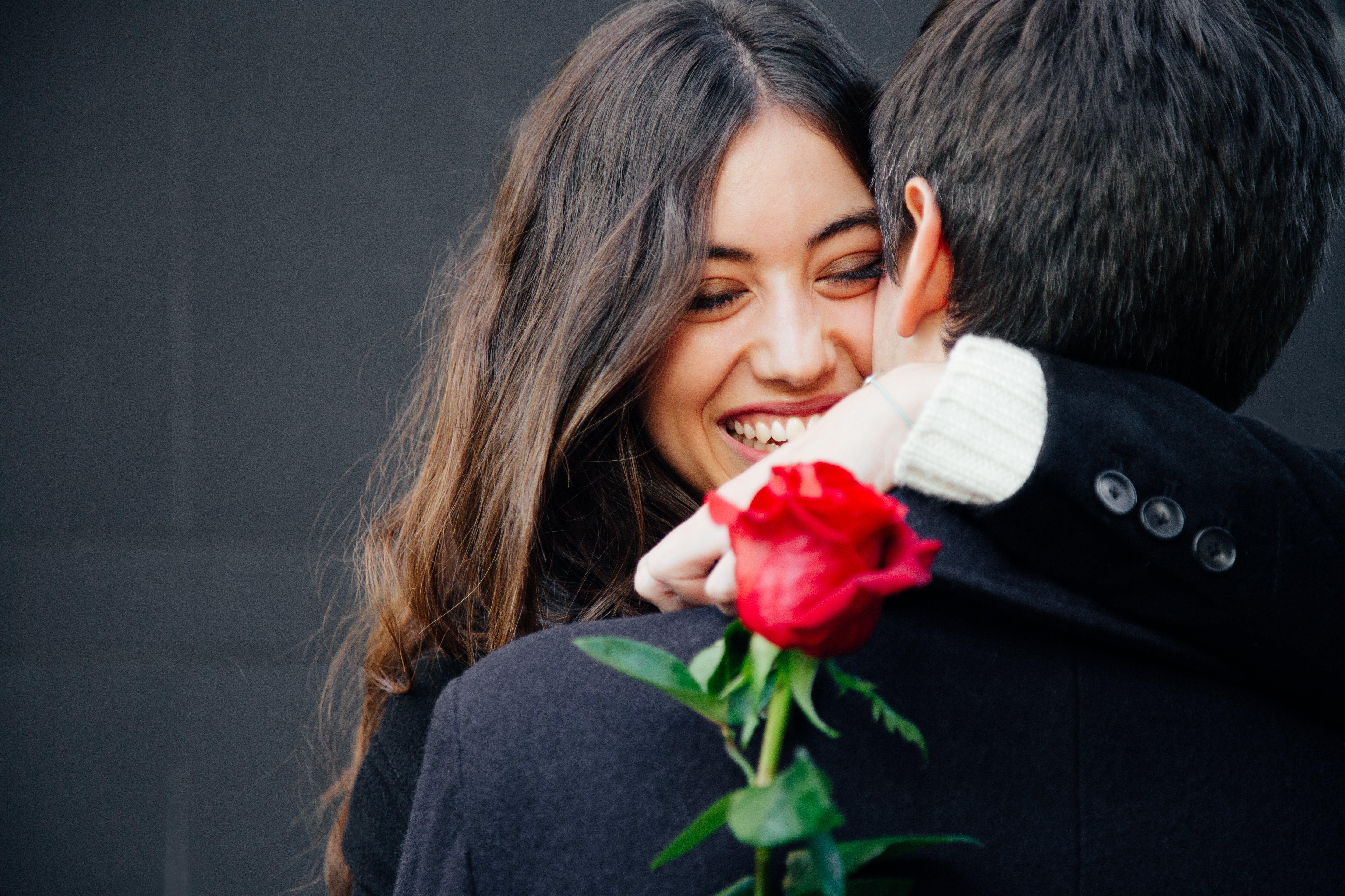 woman-hugging-man-with-rose