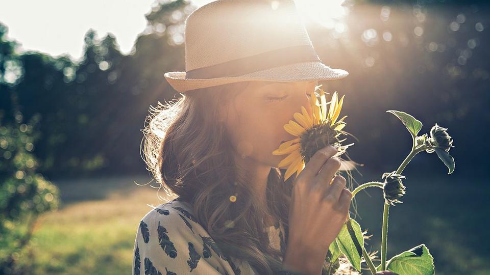 woman-sunflowers-smell-sun