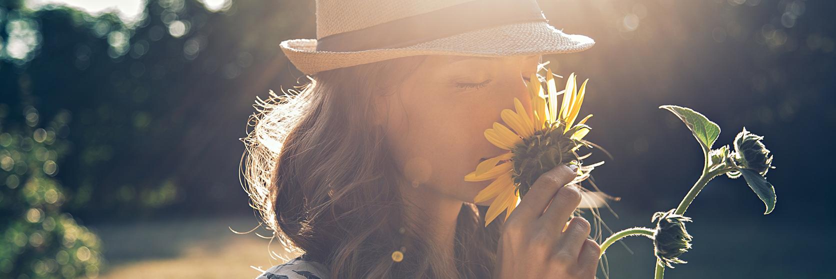 woman-sunflowers-smell-sun